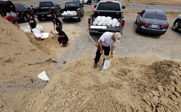 (Eric Gay | The Associated Press)  Martin Quintanilla fills sandbags as he and other residents prepare for Hurricane Harvey, Thursday, Aug. 24, 2017, in Corpus Christi, Texas.
