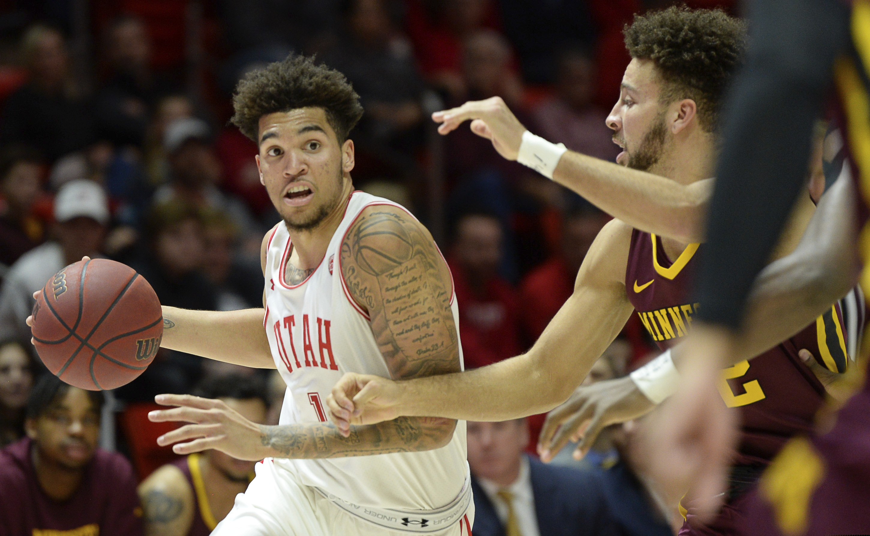 Utah forward Timmy Allen (1) moves past Minnesota guard Gabe Kalscheur (22) during an NCAA college basketball game Friday, Nov. 15, 2019, in Salt Lake City. (Francisco Kjolseth/The Salt Lake Tribune via AP)