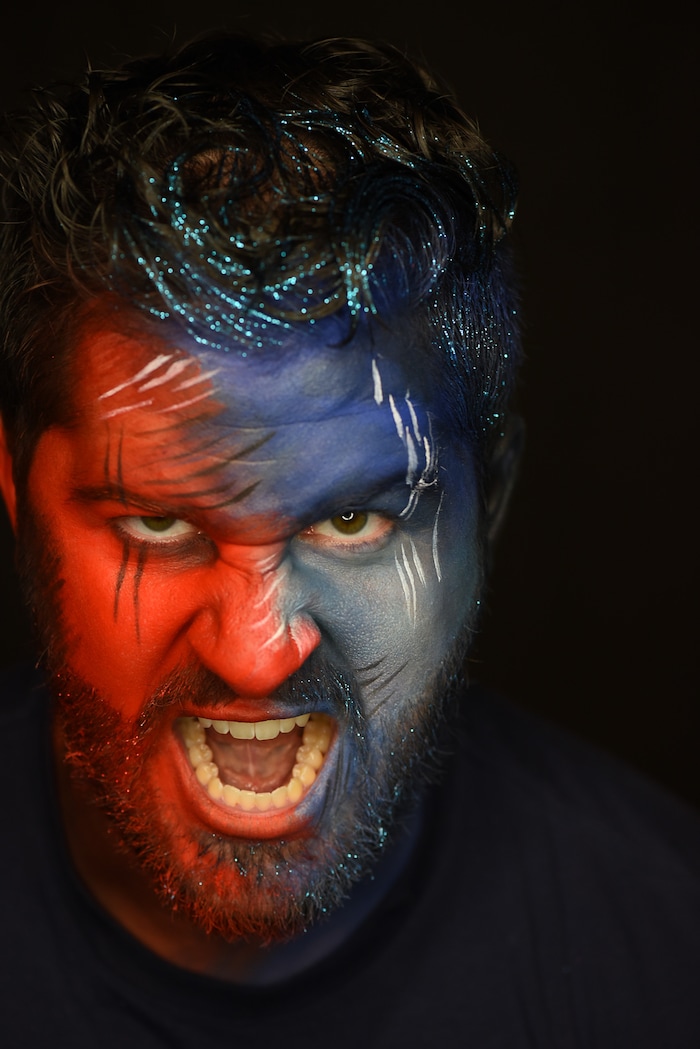(Francisco Kjolseth | The Salt Lake Tribune) BYU and Utah fan alike Brad Klekas of South Jordan shows his mutual admiration by stepping into the Tribune studio to get both colors in anticipation of the upcoming match up between the two rival teams on Saturday.