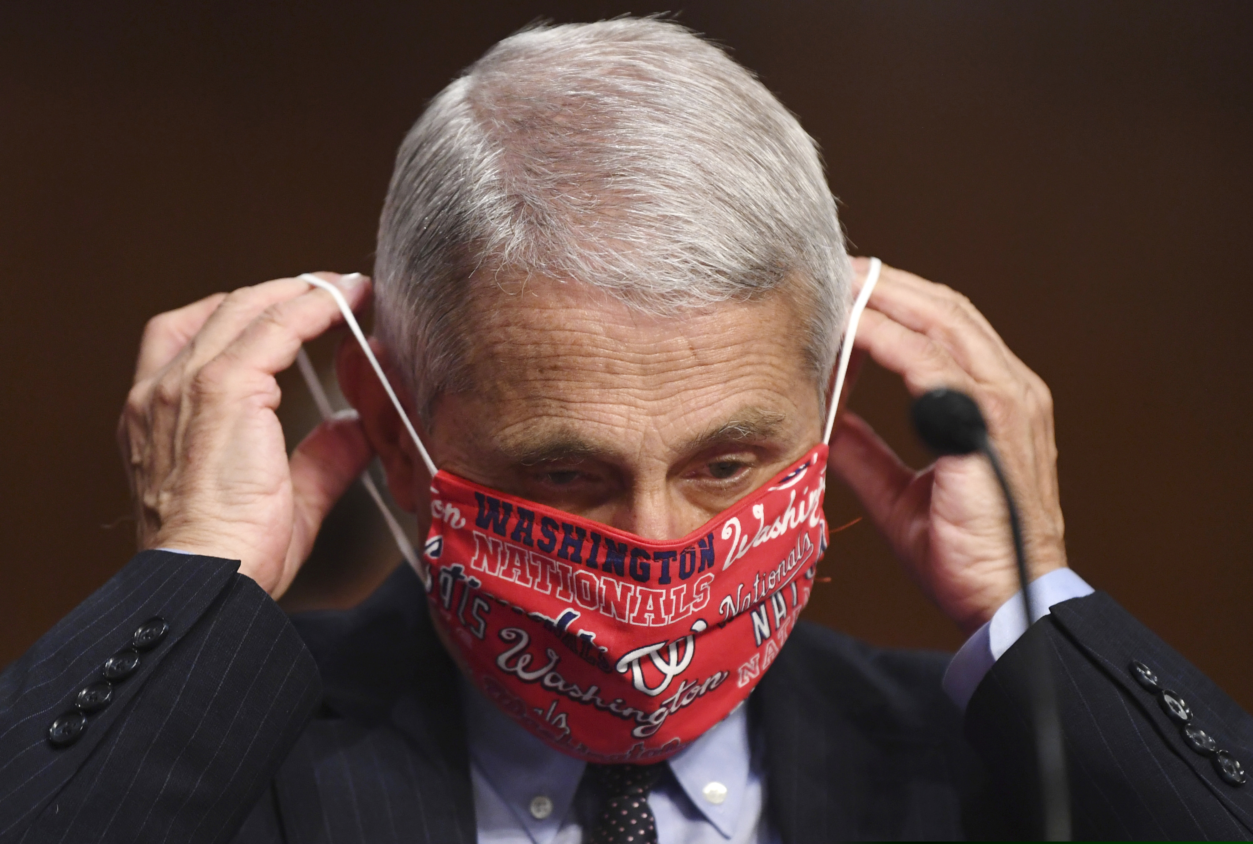 (Kevin Dietsch | pool via AP)
Dr. Anthony Fauci, director of the National Institute for Allergy and Infectious Diseases, lowers his face mask as he prepares to testify before a Senate Health, Education, Labor and Pensions Committee hearing on Capitol Hill in Washington, Tuesday, June 30, 2020.