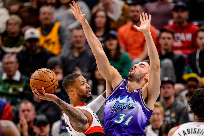 (Trent Nelson  |  The Salt Lake Tribune) Portland Trail Blazers guard Damian Lillard (0) defended by Utah Jazz forward Georges Niang (31) as the Utah Jazz host the Portland Trail Blazers, NBA basketball in Salt Lake City on Thursday, Dec. 26, 2019.