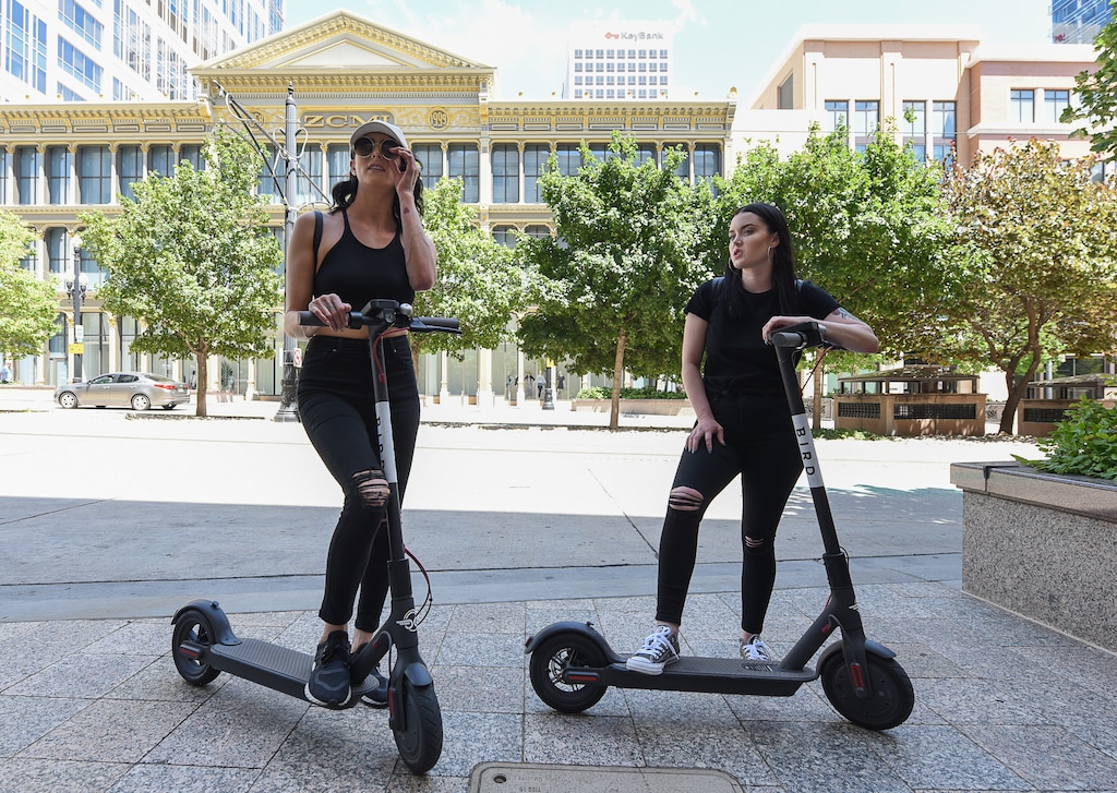 (Francisco Kjolseth | Tribune file photo) This July 3, 2018, file photo shows Jenna Dellorusso, left, and Cassandra Better with a pair of dockless e-scooters on Salt Lake City's Main Street. After years of trying to regulate the scooters through agreements and piecemeal rules, the capital city finally has approved a comprehensive ordinance aimed at ensuring the devices have clear-cut rules of the road, safety features and liability insurance.