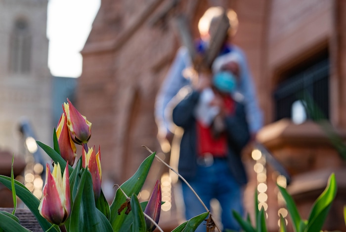 (Francisco Kjolseth | The Salt Lake Tribune) Mask wearing Utah Christians walk the streets of Salt Lake City beginning at Cathedral of the Madeleine on Good Friday, to symbolically mark Jesus' carrying the cross to his crucifixion, April 2, 2021.