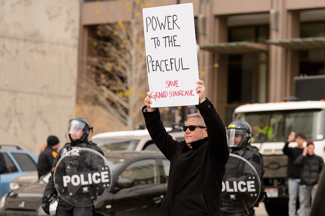 (Trent Nelson | The Salt Lake Tribune)  Protesters block off an intersection downtown after a rally against a visit by President Donald Trump, Monday December 4, 2017.