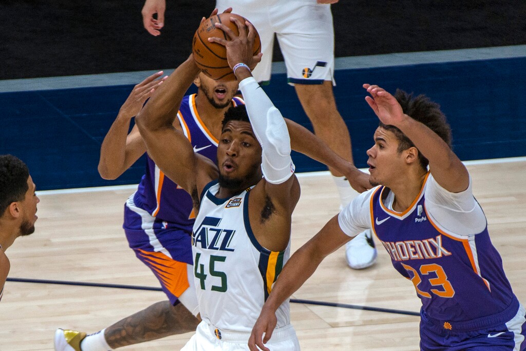 (Rick Egan | The Salt Lake Tribune) Utah Jazz guard Donovan Mitchell (45) takes the ball to the hoop, asPhoenix Suns forward Cameron Johnson (23) defends, in preseason NBA action between Utah Jazz and Phoenix Suns at Vivint SmartHome Area, on Saturday, Dec. 12, 2020.