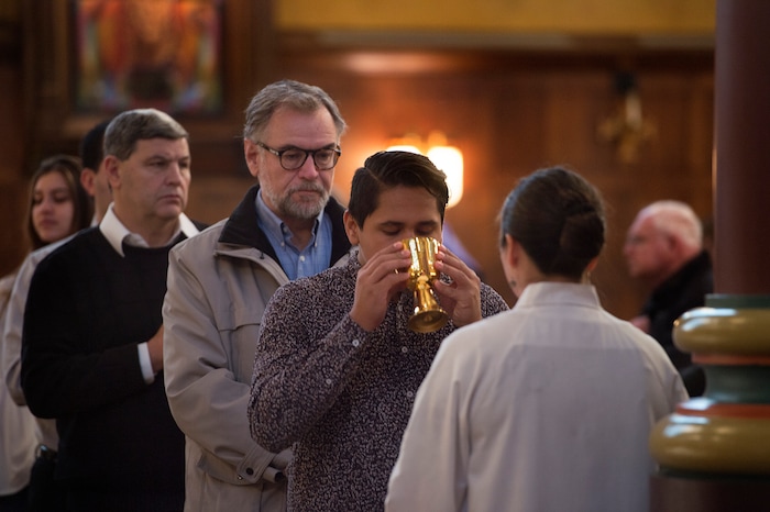 (Scott Sommerdorf   |  The Salt Lake Tribune)   Parishioners take communion during the early morning Christmas Eve mass on the fourth Sunday of Advent at the Cathedral of the Madeleine, Sunday, December 24, 2017. 