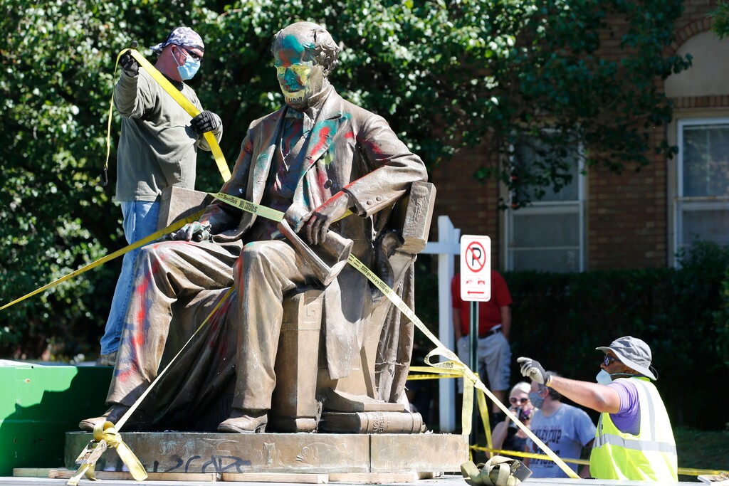 (Steve Helber | AP file photo)  Workers secure the statue of Confederate Naval officer Matthew Fontaine Maury to a truck on Monument Avenue, Thursday, July 2, 2020, in Richmond, Va.