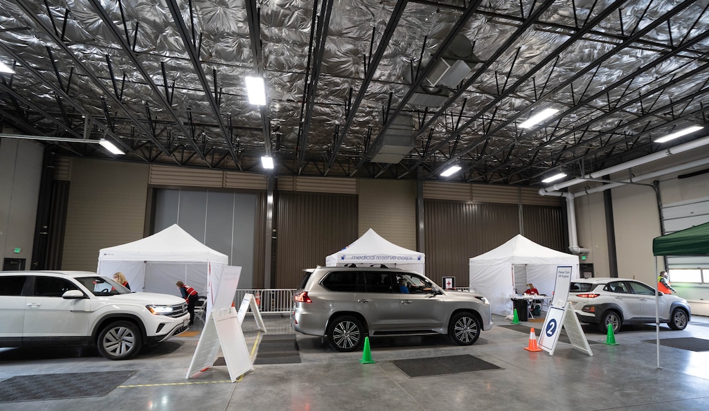 (Francisco Kjolseth  | The Salt Lake Tribune) People line up for the vaccine on Thursday, March 18, 2021, as the Utah Film Studios in Park City loans its space to the Summit County Health Department as a drive-thru COVID-19 vaccination station.