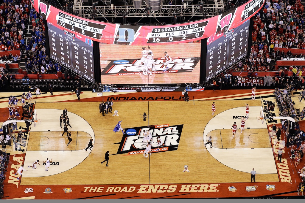 FILE - In this Monday, April 6, 2015, file photo, Duke players celebrate on the court after their 68-63 victory over Wisconsin in the NCAA Final Four college basketball tournament championship game in Indianapolis. The NCAA announced Monday, Jan. 4, 2020, that this year's 67 men's basketball tournament games including the Final Four will be played entirely in Indiana.(AP Photo/David J. Phillip, File)