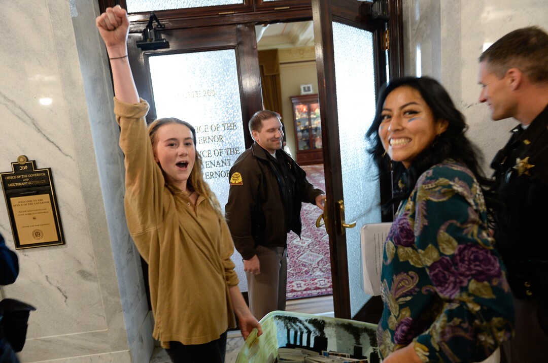(Francisco Kjolseth  |  The Salt Lake Tribune)  Nina Serafin, left, and Raquel Juarez are joined by numerous other students outside the office of Gov. Gary Herbert on the Utah Capitol on Friday, Dec. 6, 2019, as they deliver over 4,000 written cards with the importance of protecting Utah lands and clean air solutions. Because of security reasons they were told they would have to mail the cards instead. Fridays For Future, Utah Youth Environmental Solutions, and partners strike in opposition to UtahÕs final oil and gas lease sale of 2019 that will auction off public lands and further fossil fuel development.