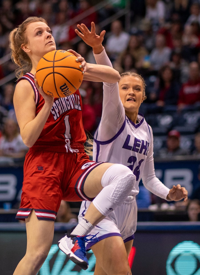 (Rick Egan | The Salt Lake Tribune) Springville Red Devils guard, Ellie Esplin (1) goes to the hoop as Lehi guard, Sammi Love (24) defends, in the girls 5A State playoff game between the Springville Red Devils and the Lehi Pioneers, at the Marriott Center in Provo, on Saturday, March 5, 2022. 
