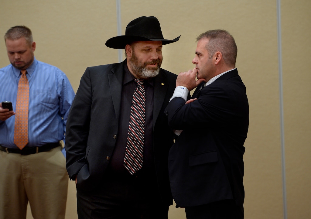 (Scott Sommerdorf   |  Tribune file photo) Rick Koerber, center, confers with his attorney Marcus Mumford in August 2014. Koerber is on trial on federal court on 18 charges related to his operation of a real estate investment business in Utah County.