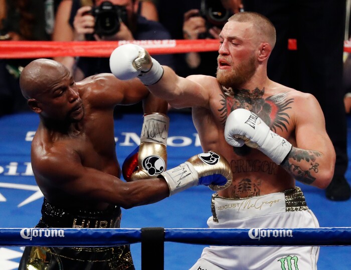 (AP Photo | Eric Jamison) Conor McGregor, right, fights Floyd Mayweather Jr. in a super welterweight boxing match Saturday, Aug. 26, 2017, in Las Vegas.