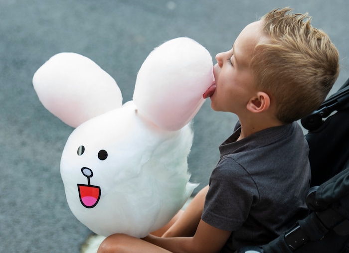 (Rick Egan  |  The Salt Lake Tribune)    
Sam Saunders, 4, from Clinton, bites into  a rabbit made of cotton candy, from the Sweet Art booth, at the Utah State Fair Monday, Sept. 9, 2019.