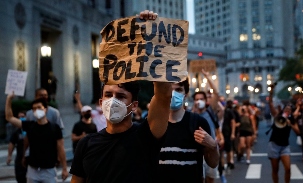 (AP Photo/John Minchillo, File)

This photo from Thursday July 30, 2020, shows a demonstrator holding a sign that reads "Defund the police" during a protest march in New York.