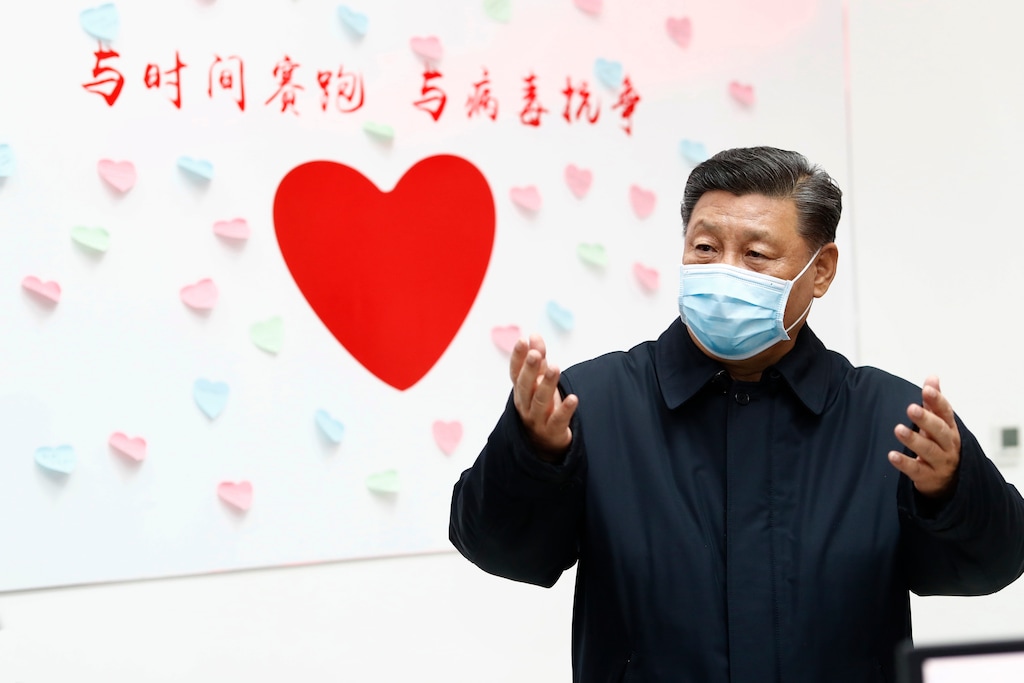 (Liu Bin | Xinhua via AP file photo) Chinese President Xi Jinping gestures near a sign with the slogan "Race against time, Fight the Virus" during an inspection of the center for disease control and prevention of Chaoyang District in Beijing on Feb. 10, 2020.