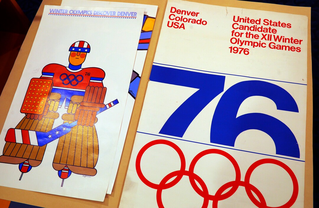 In this Feb. 1, 2018, photograph, one of the posters used in Colorado's effort to secure an Olympic bid in 1976 is part of the memorabilia collection of the Denver Public Library in Denver. Over 40 years after becoming the first city to walk away from an Olympic bid, Denver is considering whether to try to again to host the Winter Games. (AP Photo/David Zalubowski)