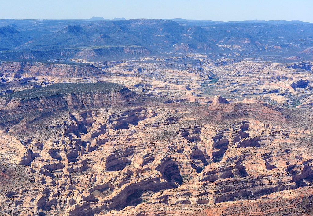 (Francisco Kjolseth | The Salt Lake Tribune) The two buttes that make up the namesake for the Bears Ears National Monument can be seen in the distant horizon line as EcoFlight takes journalists, tribal people and activists over the Bears Ears Monday, May 8, 2017. The Utah Legislature has approved a deal to swap state trust lands in and around the monument for 165,000 federal acres in 21 counties.
