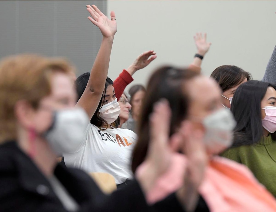 (Eli Lucero | Herald Journal) Residents raise their hands to show support for a comment made during a Cache County Board of Education meeting.