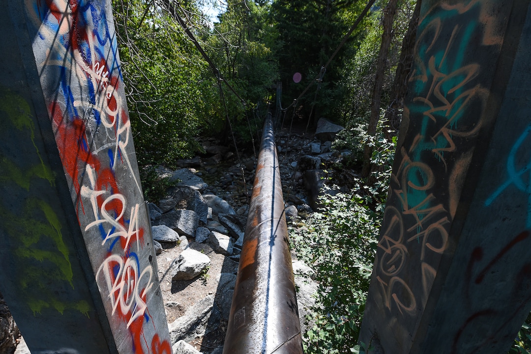 (Francisco Kjolseth  |  The Salt Lake Tribune)  Graffiti has proliferated in lower Little Cottonwood Canyon, where vandals, often wielding cans of fluorescent-colored spray paint, have covered granite faces, trees and structures. The vandalism is particularly apparent along the Temple Quarry Trail and the creek at the Moon Rock swimming hole and former pavilion site. Volunteers using donated equipment and solvents spend thousands of hours removing the paint from the rocks only to see graffiti return to the same faces or on rock nearby.