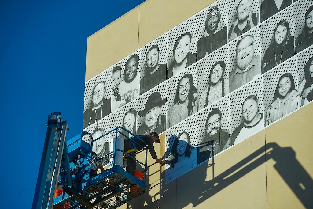 (Chris Detrick | The Salt Lake Tribune) Alexander Pierre and Jaime Scatena hang portraits of Inside Out/Dreamers Project participants on the Salt Lake City Public Library Tuesday, November 21, 2017. The Inside Out Project is a global participatory art project that gives everyone the opportunity to share their portrait and express what they stand for. In Utah, the future of more than 10,500 DACA recipients is being threatened by President TrumpÕs decision to end the popular and successful DACA program. The Center for American Progress estimates that Utah has 19,000 Dream Act-eligible individuals in the workforce and would see annual state GDP gains of $206 million from passage of the Dream Act.