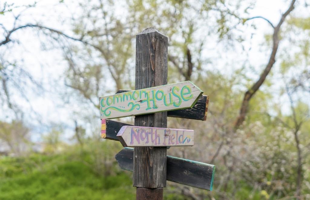 (Vicky Wason | Wasatch Commons) Directional signs point residents of Wasatch Commons, a cohousing community in Salt Lake City's Glendale neighborhood, to shared facilities such as the Common House, where they gather regularly for meals and activities.