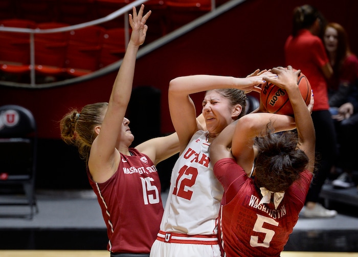 Scott Sommerdorf   |  The Salt Lake Tribune  
Utah Utes forward Emily Potter (12) battles for control of a rebound with Washington State Cougars forward Ivana Kmetovska (15) and Utah Utes center Megan Huff (5) during first half play. Washington State beat Utah 61-55, Sunday, February 5, 2017. 