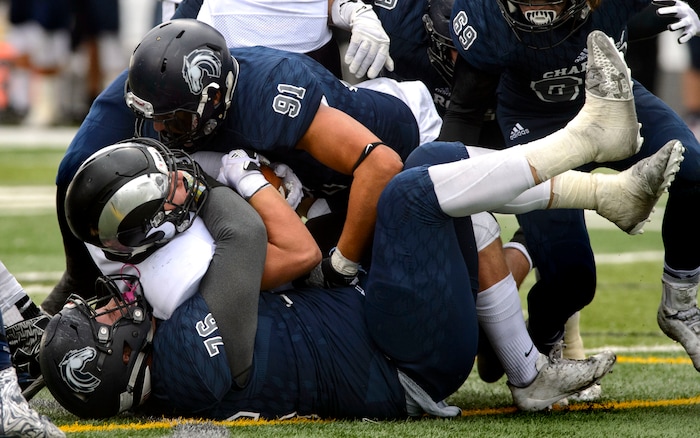 (Steve Griffin  |  The Salt Lake Tribune)  Highland quarterback Cole Peterson gets swallowed up by the Corner Canyon defense during the Class 5A state quarterfinal football game at Corner Canyon in Draper Friday November 3, 2017.