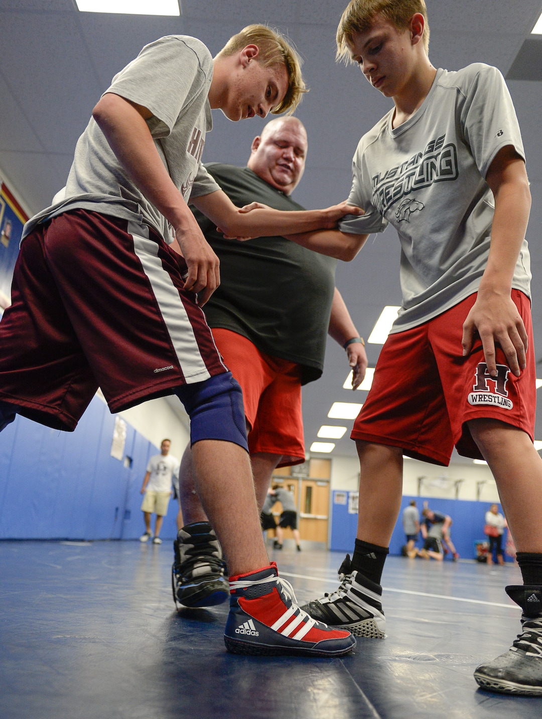 (Francisco Kjolseth  |  The Salt Lake Tribune)  Olympic wrestling champion Rulon Gardner runs an introductory clinic with young wrestlers Trey Holliday, 15, left, and Jaxon Bearden, 14, at Herriman High School after being introduced as the new coach on Wed. May 17, 2018.