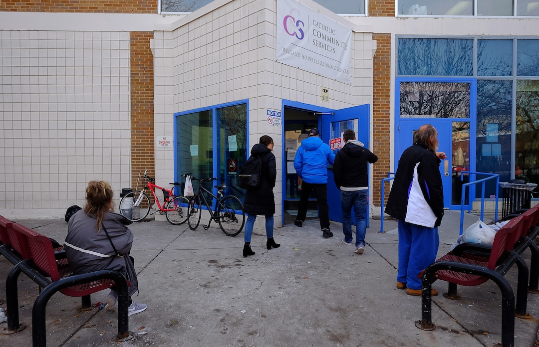 (Francisco Kjolseth  |  The Salt Lake Tribune) People enter the Weigand Center in Salt Lake City where Catholic Community Services runs a weekly town hall meeting to get more input from its homeless clients. The organization is seeking feedback, through surveys at kiosks created by Pulse for Good, a Utah-based company.