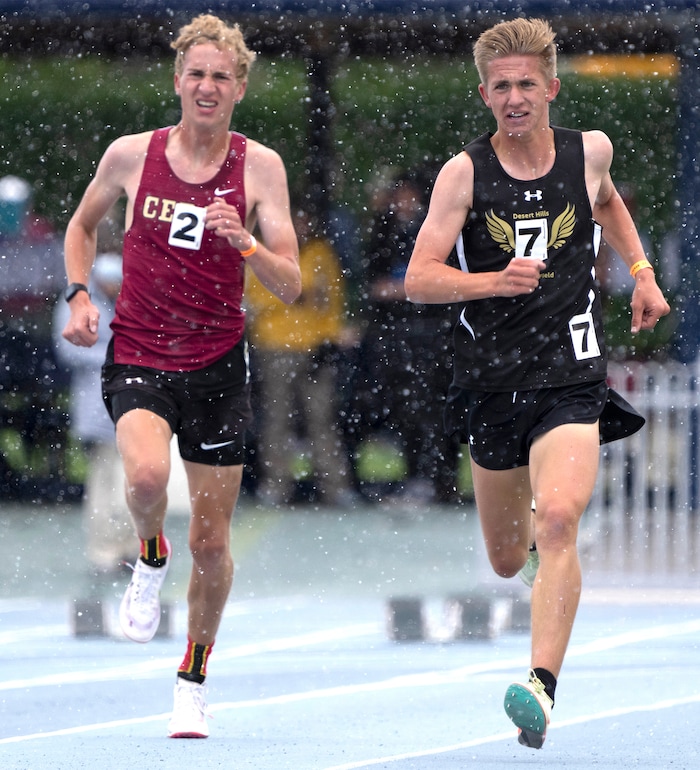 (Rick Egan | The Salt Lake Tribune) Brooks Barney leads Logan Peel, in the snowy home stretch of the 4A Boys 3200 meter final for first place, at the Utah State High School Track Championship in Provo, on Friday, May 20, 2022.
