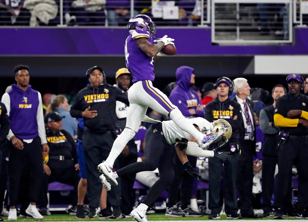 Minnesota Vikings wide receiver Stefon Diggs (14) makes a catch over New Orleans Saints free safety Marcus Williams (43) on his way to the game winning touchdown during the second half of an NFL divisional football playoff game in Minneapolis, Sunday, Jan. 14, 2018. The Vikings defeated the Saints 29-24. (AP Photo/Jeff Roberson)