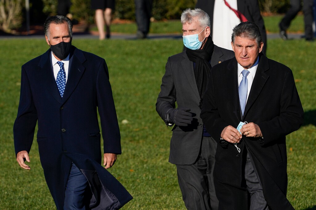 (Susan Walsh | AP) Sen. Mitt Romney, R-Utah, Sen. Bill Cassidy, R-La., and Sen. Joe Manchin, D-W.Va., arrive before President Joe Biden signs the $1.2 trillion bipartisan infrastructure bill into law during a ceremony on the South Lawn of the White House in Washington, Monday, Nov. 15, 2021.