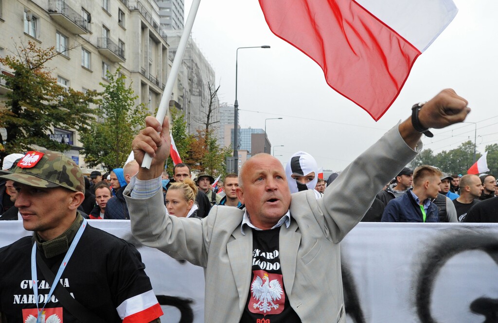 Protesters shout anti migrant slogans as several thousand right wing nationalists march through downtown, demonstrating against EU proposed quotas for Poland to spread the human tide of refugees around Europe, in Warsaw, Poland, Saturday, Sept. 12, 2015. (AP Photo/Alik Keplicz)