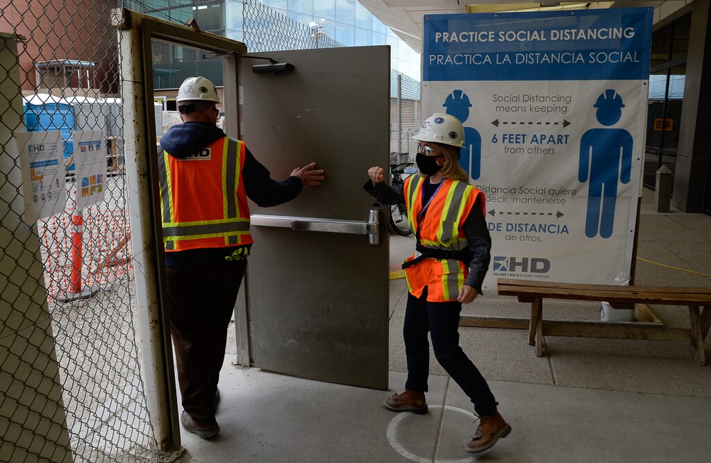 (Francisco Kjolseth | The Salt Lake Tribune) Signs encouraging social distancing are displayed due to the ongoing battle against COVID-19 as crews continue their work in the first phase of construction of the Salt Lake City International Airport on Wednesday, May 20, 2020.