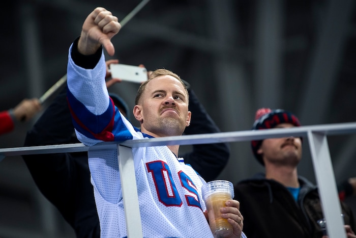 (Chris Detrick  |  The Salt Lake Tribune)  A USA fan gives a thumbs down to Russian fans after Russia scored a goal during the United States vs Olympic Athletes from Russia hockey game at Gangneung Hockey Centre during the Pyeongchang 2018 Winter Olympics Saturday, Feb. 17, 2018. Olympic Athletes from Russia defeated United States 4-0.
