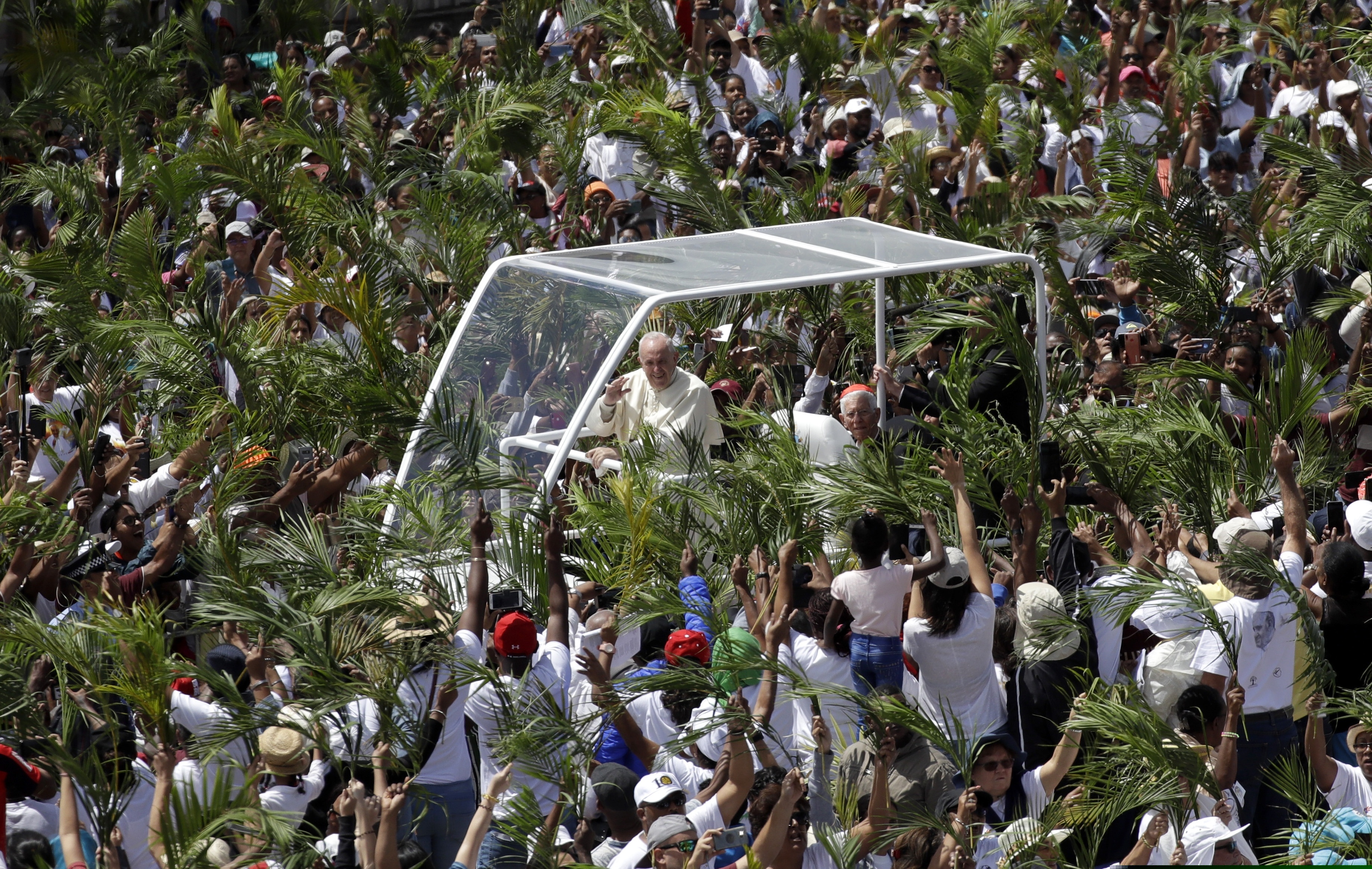(Alessandra Tarantino | The Associated Press) Faithful wave palm leaves as Pope Francis arrives to celebrate Mass at the Monument Mary Queen of Peace, in Port Louis, Mauritius, Monday, Sept. 9, 2019.