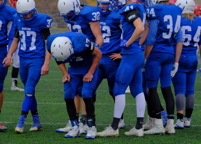 (Leah Hogsten  |  The Salt Lake Tribune) Teammates check on Beaver's quarterback Porter Hollingshead who favors one of his legs.  Beaver High School boys' football team defeated Delta High School 35-16 during their class 2A state semifinal football game Saturday, November 4, 2017 at Weber State University's Stewart Stadium.