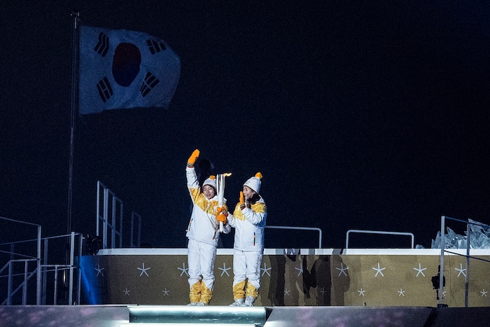 (Chris Detrick  |  The Salt Lake Tribune)  North Korea's Jong Su Hyon, left, and South Korea's Park Jong-ah carry the torch during the Pyeongchang 2018 Winter Olympics opening ceremony at Olympic Stadium Friday, February 9, 2018.  