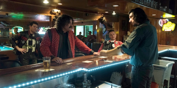(Claudette Barius  |  Fingerprint Releasing/Bleecker Street) Bartender Clyde Logan (Adam Driver, right) contends with arrogant tycoon Max Chilblain (Seth MacFarlane) and his entourage, in Steven Soderbergh's caper comedy "Logan Lucky."