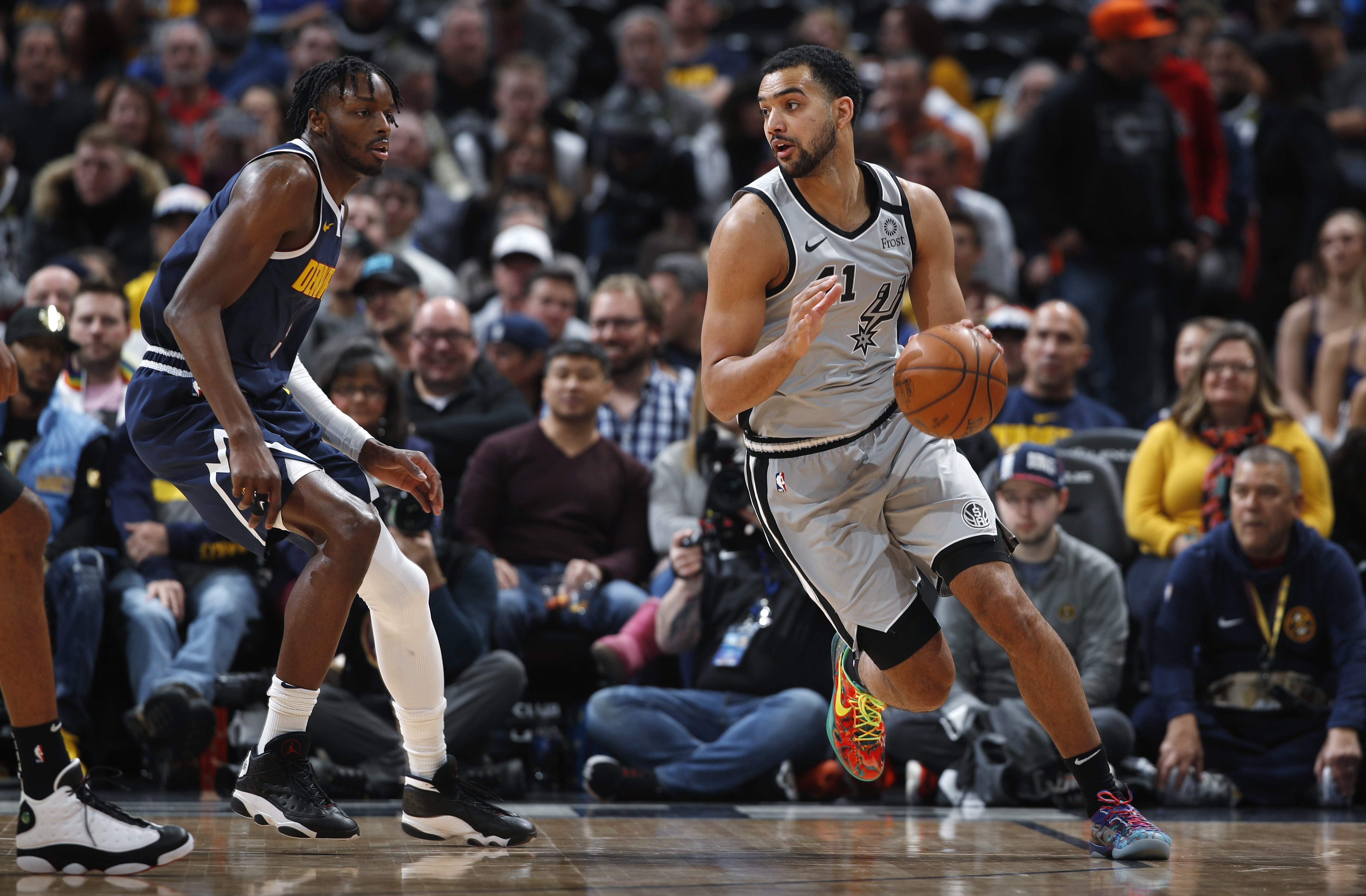 San Antonio Spurs center Trey Lyles, right, drives past Denver Nuggets forward Jerami Grant in the first half of an NBA basketball game Monday, Feb. 10, 2020, in Denver. (AP Photo/David Zalubowski)