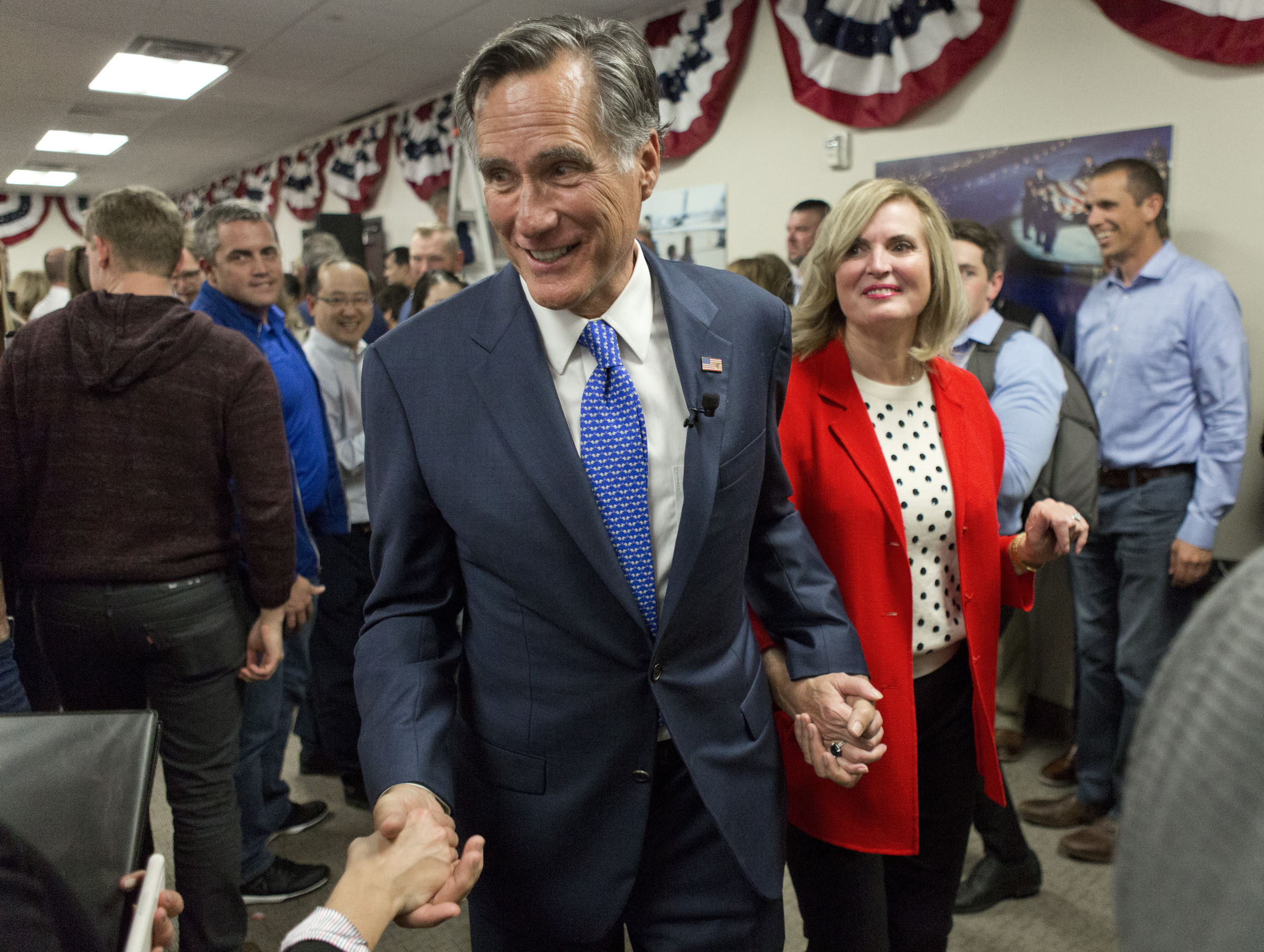 Mitt Romney, U.S. Sen. candidate, exits the conference room with his wife, Ann, at his headquarters after giving a victory speech on Tuesday, Nov. 6, 2018, in Orem, Utah. (Evan Cobb/The Daily Herald via AP)