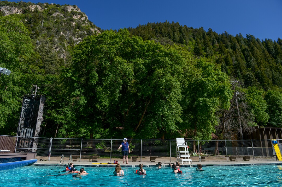 (Leah Hogsten  |  The Salt Lake Tribune) Students in BSA's Camp Tracy beginning lifeguard class taught by Polly Butler-Jette, center, learn how to pull victims from the water using a rescue board, Thursday, May 24, 2018. The three girls and four boys in the class will assume lifeguarding duties at boy scout camps throughout Utah this summer. 