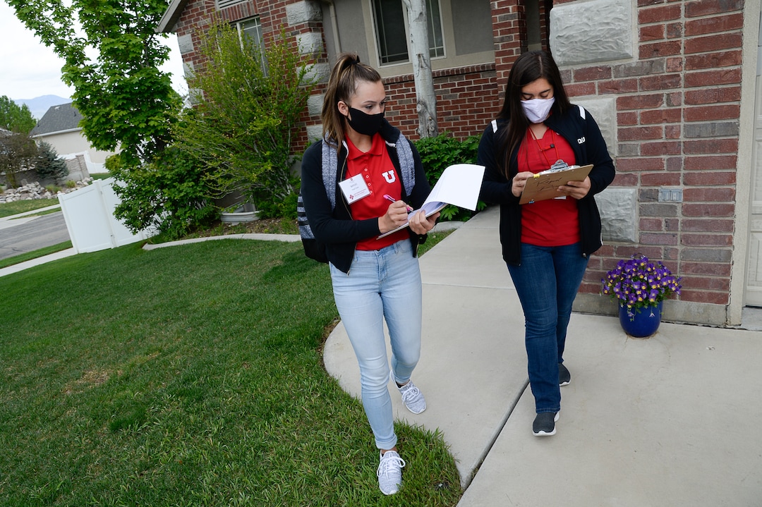(Francisco Kjolseth  |  The Salt Lake Tribune) University of Utah students Baylee Tollerud, left, and Raquel Bucio, visit randomly selected households in Herriman on Thursday, May 4, 2020, to explain the Utah Health & Economic Recovery Outreach program in hopes of finding people willing to be tested for COVID-19, to find out how widespread the disease actually is in the state. Educators and business leaders are hoping the HERO program, where college-age volunteers are now randomly finding residents to be tested for COVID-19, will blossom into something bigger. They are proposing to expand it into what will be called Hope Corps, with hundreds of students and other volunteers offering hands-on advice and resources to restaurants and retailers who's businesses are struggling in the pandemic.