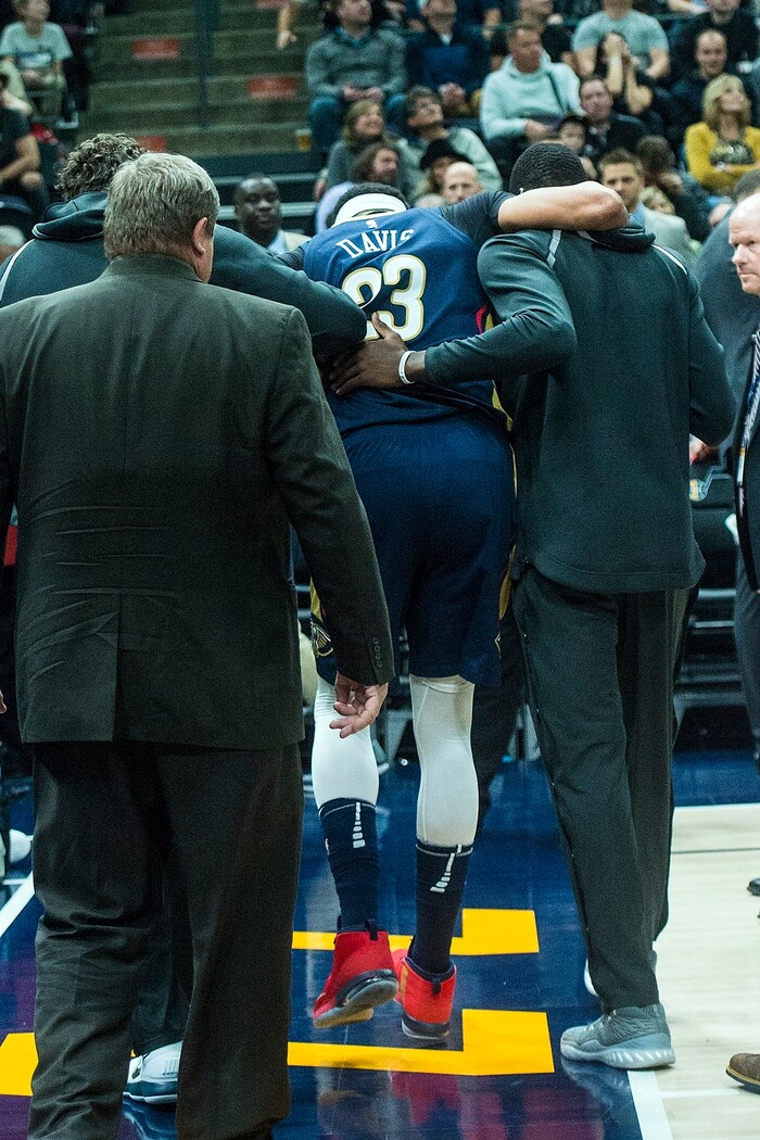 (Chris Detrick  |  The Salt Lake Tribune)  New Orleans Pelicans forward Anthony Davis (23) is helped off of the court after getting injured during the game at Vivint Smart Home Arena Friday, December 1, 2017.  Utah Jazz defeated New Orleans Pelicans 114-108.