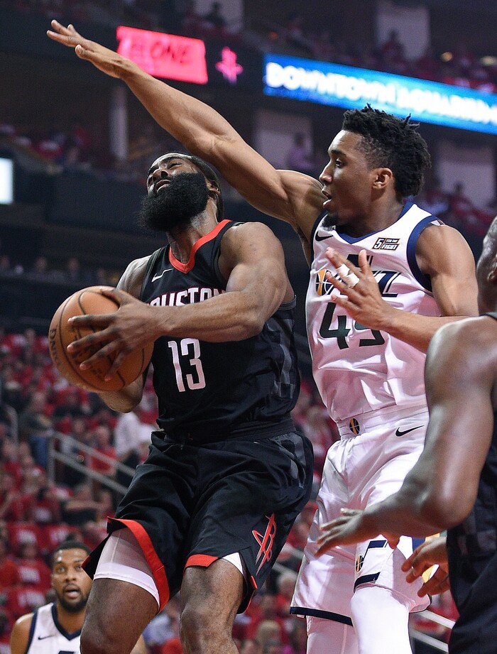 Houston Rockets guard James Harden (13) drives to the basket as Utah Jazz guard Donovan Mitchell, right, defends during the first half in Game 2 of an NBA basketball second-round playoff series Wednesday, May 2, 2018, in Houston. (AP Photo/Eric Christian Smith)
