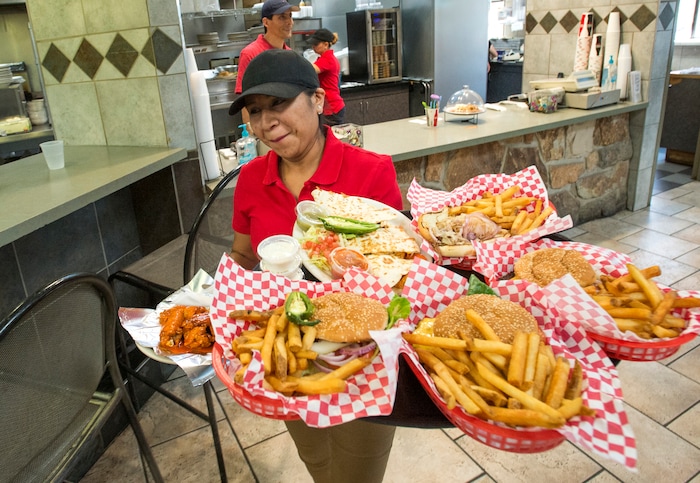 (Rick Egan  |  The Salt Lake Tribune)  Waitress Elizabeth Nava delivers food to customers at The Silver Summit Cafe in Park City.
