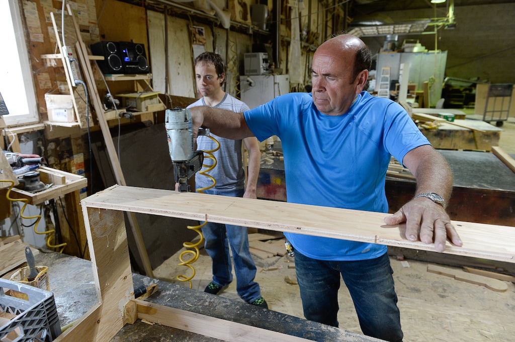 (Francisco Kjolseth | Tribune file photo) Kerry Hamblin, owner of Hamblin Custom Furniture Frames, works in his shop next to UTA headquarters with his son Ryan, left, in June 2014.