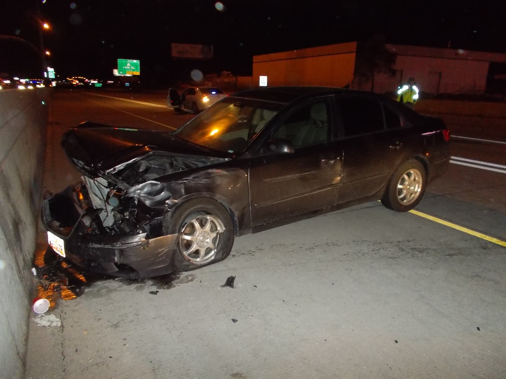(Photo courtesy of Utah Highway Patrol)  A man crashed his car into a concrete barrier on Interstate 15 in South Salt Lake on Saturday morning. He then ran across traffic and was hit by multiple vehicles, killing him.