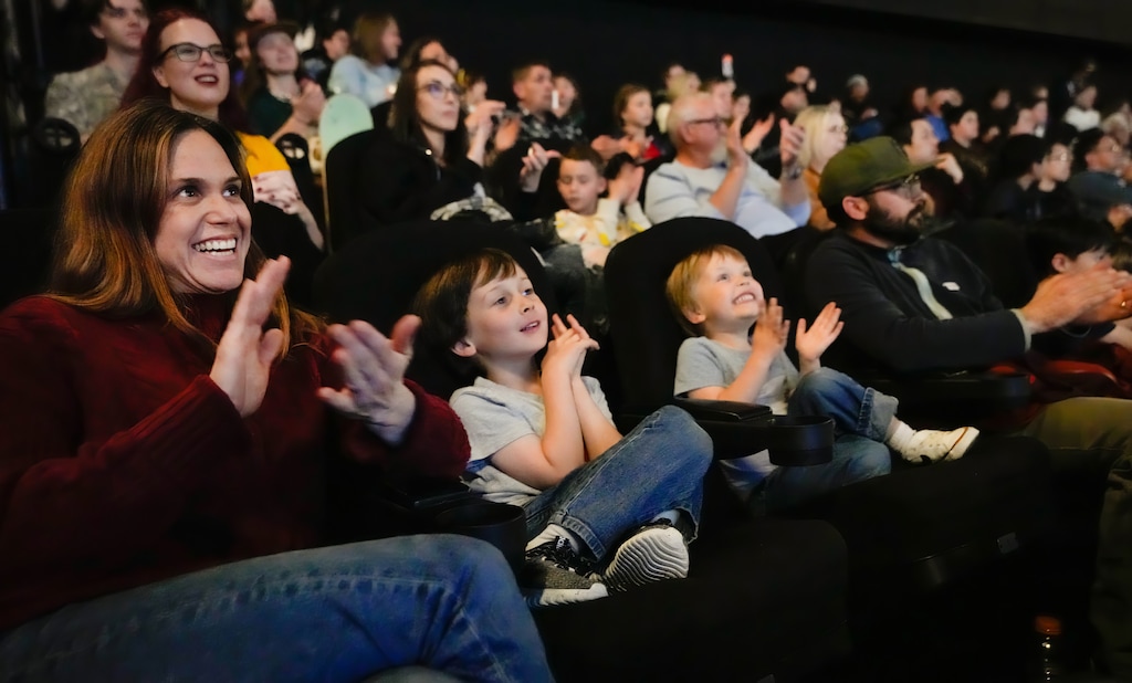 (Francisco Kjolseth | The Salt Lake Tribune) Emily Bedell and her husband Nick, are joined by their sons Will, 6, and Louie, 3, as they cheer on the launch of Artemis II with four astronauts headed around the moon during a watch party in the IMAX theater at Clark Planetarium on Wednesday, April 1, 2026.
